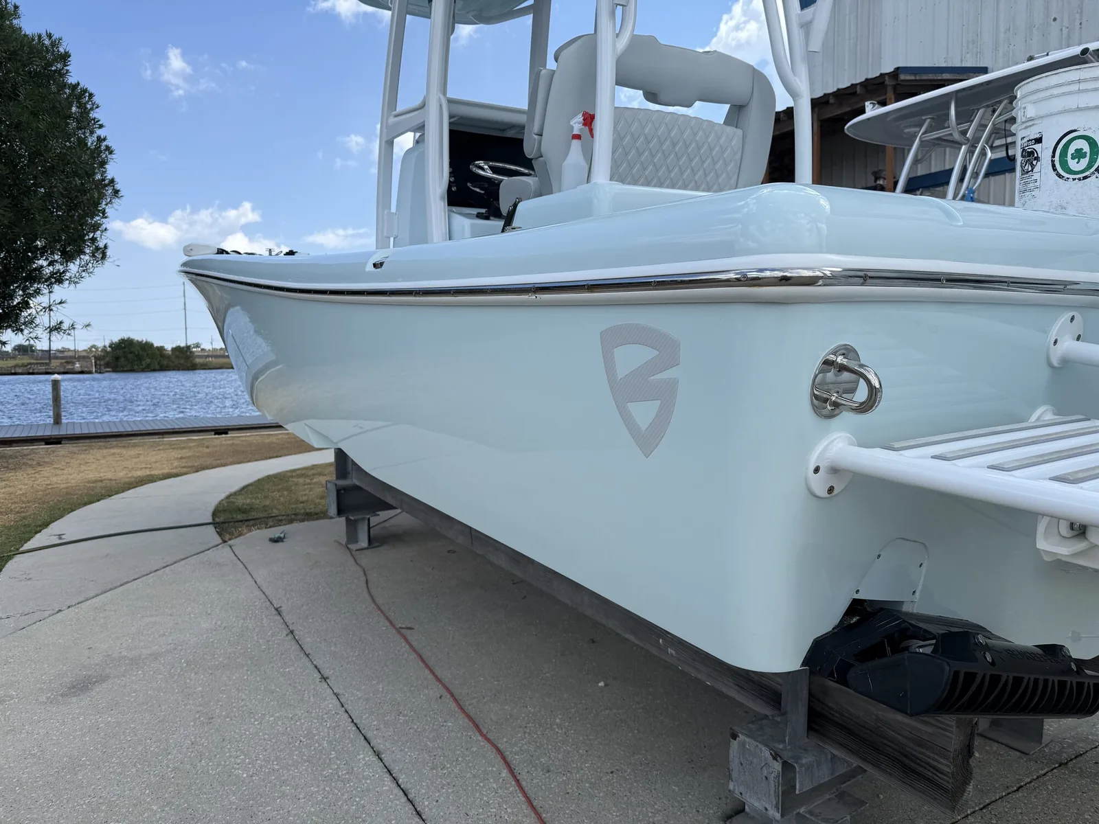 Clean light-blue center-console boat at a dock.